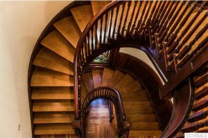 A winding staircase climbs the house's three floors.