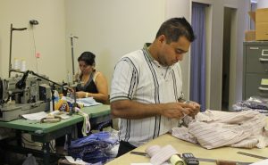 Maria Argueta and Abel Mendoza sew custom shirts at Creery. 