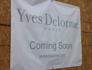 Yves Delorme has a sign announcing its arrival at River Road. Orvis does not. 