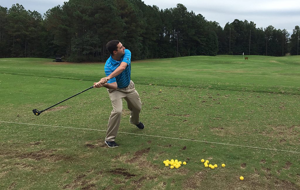 Smitty Smithson, assistant pro at Hunting Hawk Golf Club, flings balls at the driving range. (Michael Schwartz)