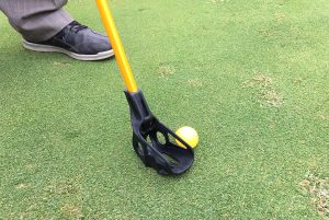 FlingGolf allows players to toss and putt a standard golf ball using a hybrid of a golf club and lacrosse stick. (Michael Schwartz)