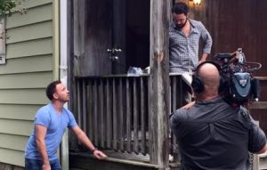 Josh Romano discusses the deck to be removed with a crew member during filming. (Courtesy Breese Romano)