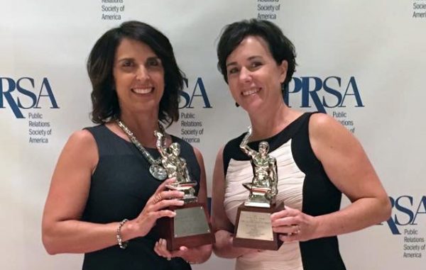 Virginia Lottery’s Jill Vaughan, left, and Jennifer Mullen with the Silver Anvils the lottery won for its work with Padilla.