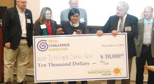 Hanover Tech Challenge winner Holly Chen accepts a check for $10,000 from William Daughtrey, head of the Dominion Resource Innovation Center. (Photo by Lena Price)