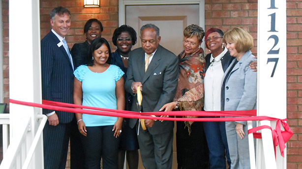 At the opening: Gary Gore, Bank of America Virginia state president, left; Dionne Nelson (back row), Laurel Street Residential chief executive; Tasha Burgo, Highland Grove resident; Adrienne Goolsby, Richmond Redevelopment and Housing Authority chief executive; Mayor Dwight Jones; City Council member Ellen Robertson; Penny Gregory, owner of A Penny for Your Thoughts Cleaning Services; and Susan Dewey, Virginia Housing Development Authority executive director. (Photos by Burl Rolett)