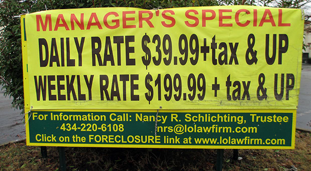 A "manager's special" banner draped over the foreclosure sign.