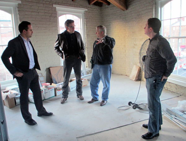 Leasing agent Matthew Mullett, left, architect Chris Fultz, Feedback's Jeff Thompson and Dean Browell tour the agency's future home on the fourth floor of 1401 E. Cary St. (Photo by Brandy Brubaker)