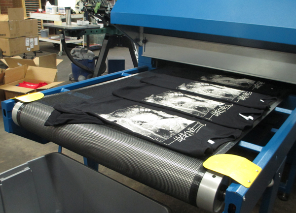 The conveyor belt dryer that cures the ink into shirts. 