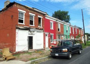 The string of houses was originally long-neglected and covered in colorful paint.  Photo by Brandy Brubaker, June 2014.