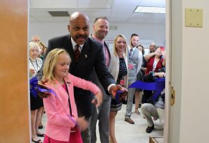 From left: Mariya Smith, 9, cuts the ribbon on the Detectamet facility with help from Maurice Jones for her parents, Detectamet Chairman Sean Smith and President Angela Musson-Smith.