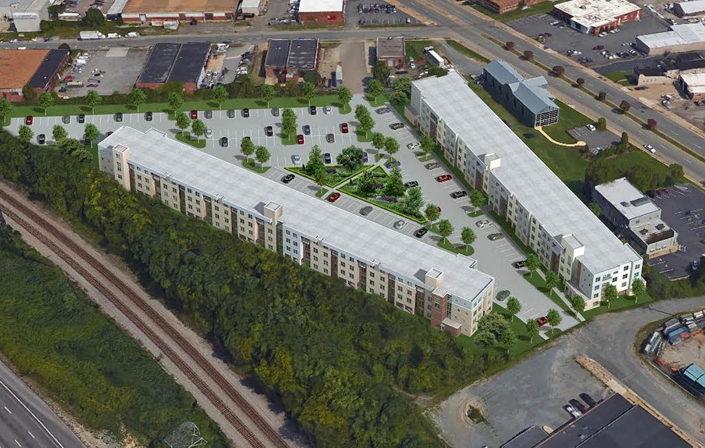 Plans call for two buildings comprising 200 apartments and straddling a central surface parking lot.