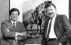 Stephen with his brother David Martin, right, beside a picture of their father, cowboy-adman Hawley Martin. (Courtesy Stephen Martin)