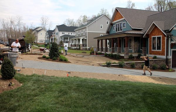 Builders put finishing touches on homes at the Hallsley model home court. (Jonathan Spiers)