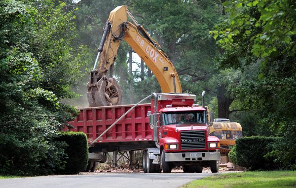 Crews pile debris into a dump truck on the property at 101 S. Ridge Road. (Jonathan Spiers)