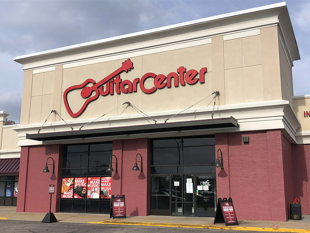 Guitar center parent deals company