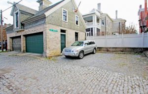 The property includes a four-car carriage house with an unfinished upper floor, a paved driveway and off-street parking. (Courtesy CVRMLS)