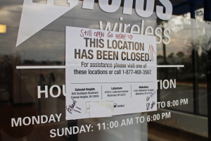 A sign on an nTelos door directs customers to the three stores that are still open. Photo by Michael Schwartz.